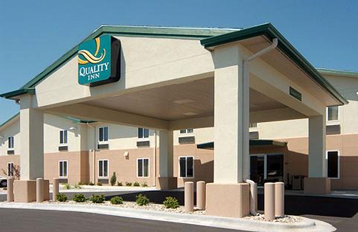 Quality Inn hotel exterior with covered entrance and beige facade
