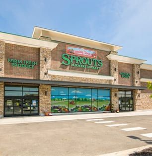 Sprouts Farmers Market storefront with stone facade and large windows on a sunny day