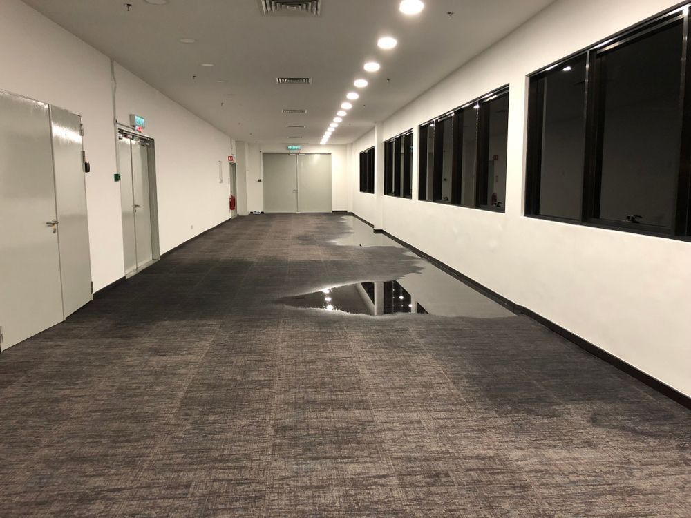 A long hallway with a puddle of water on the floor