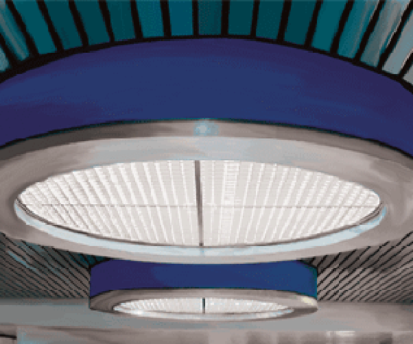 A blue ceiling with a round light hanging from it