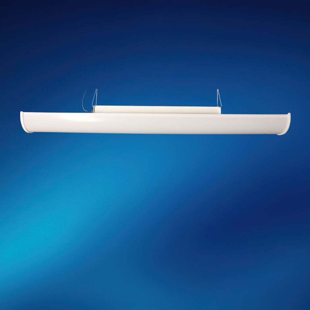 A white light fixture is hanging from the ceiling on a blue background.