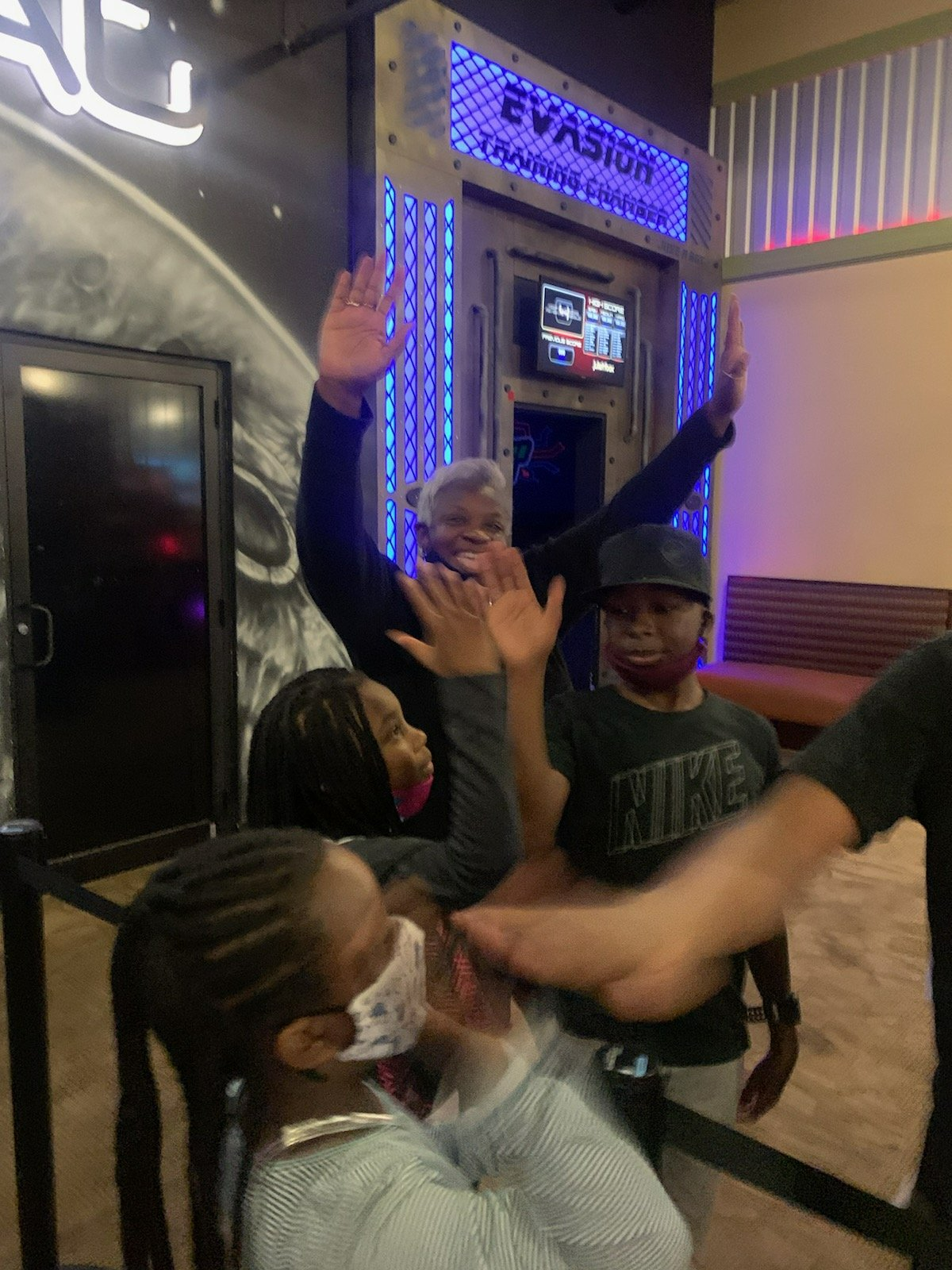 People celebrating with high fives in front of an 
