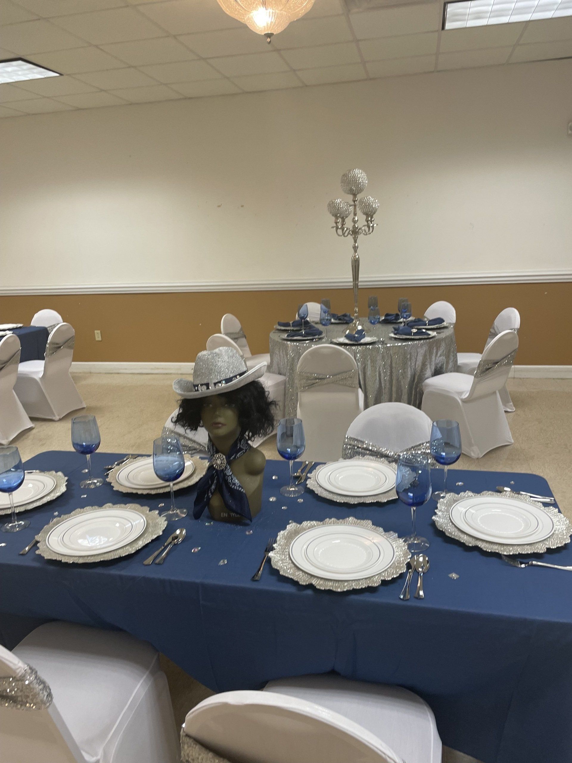 Elegant table setting with blue and silver accents in a banquet hall.