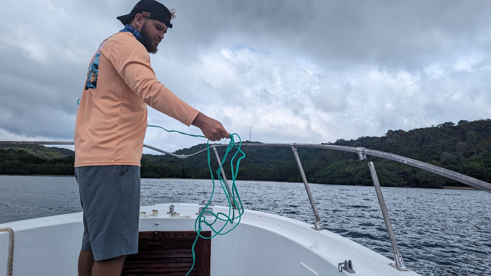 A fisherman prepares to cast a net for bait.