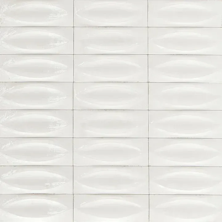 White textured tiles with a subtle repeating oval pattern and light gray grout lines