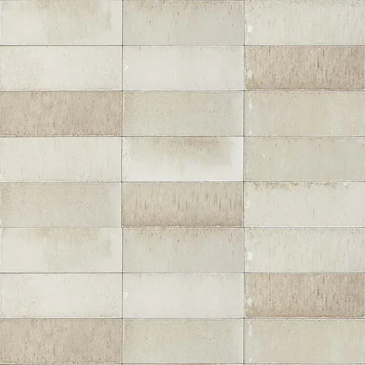 Light beige brick wall with a subtle grid pattern and weathered texture