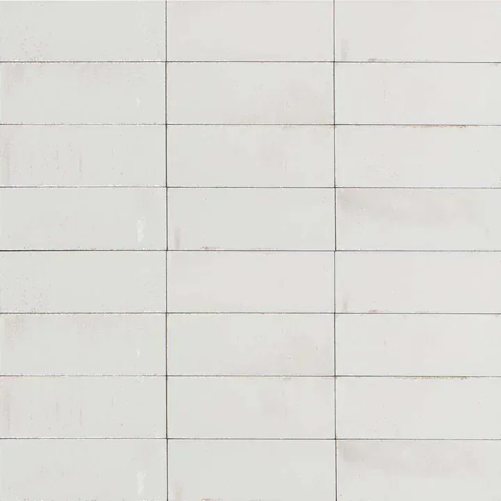 White tiled wall with horizontal and vertical gray grout lines forming a grid pattern