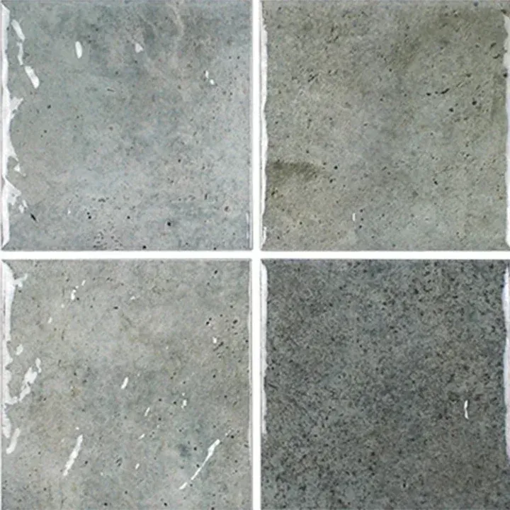 Four gray stone or concrete tiles in a 2x2 grid, each with a slightly different texture.