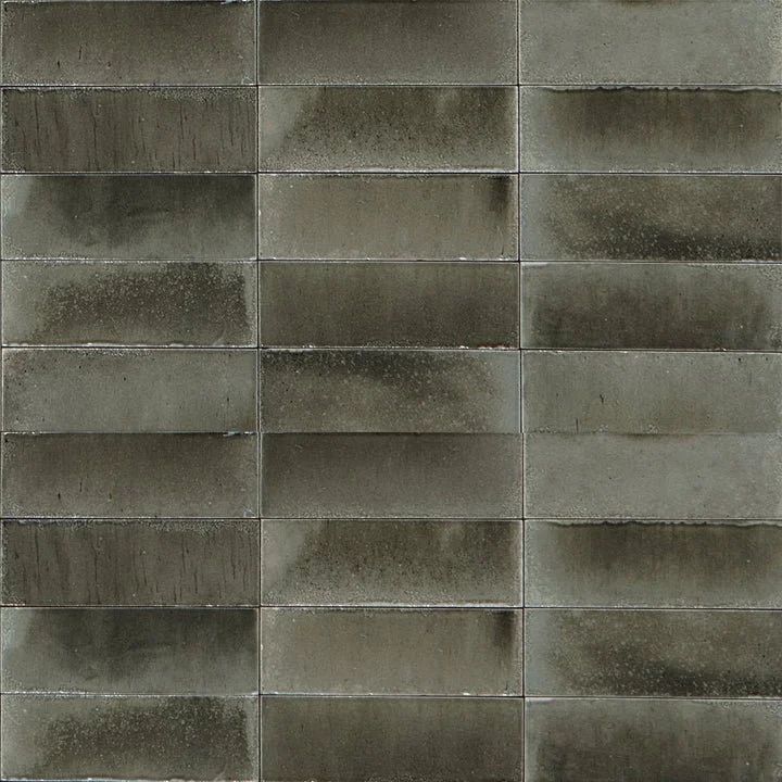 Gray concrete block wall with horizontal mortar lines and weathered stains