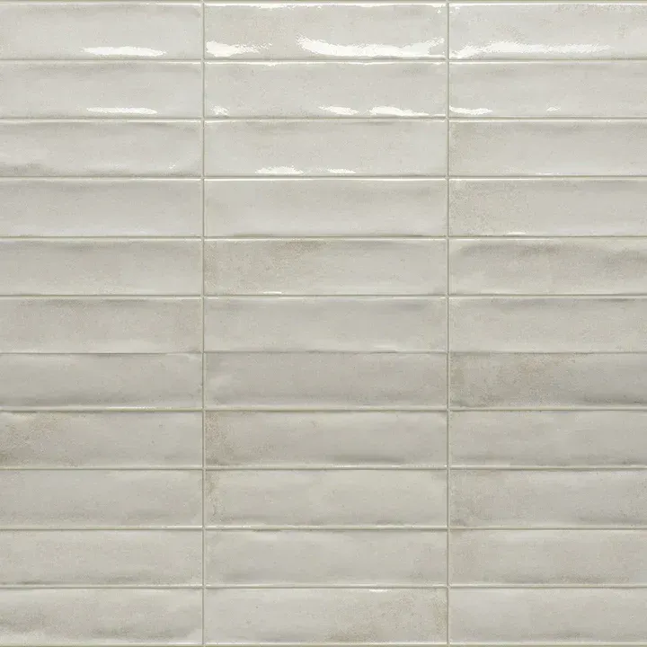 Close-up of glossy white ceramic subway tiles with light grout lines