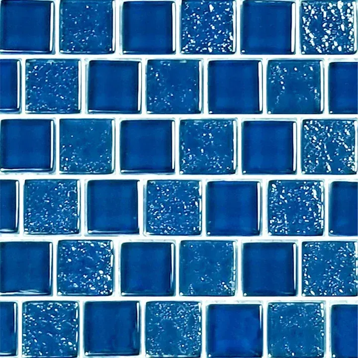 Blue glass mosaic tile wall with glossy, textured square tiles