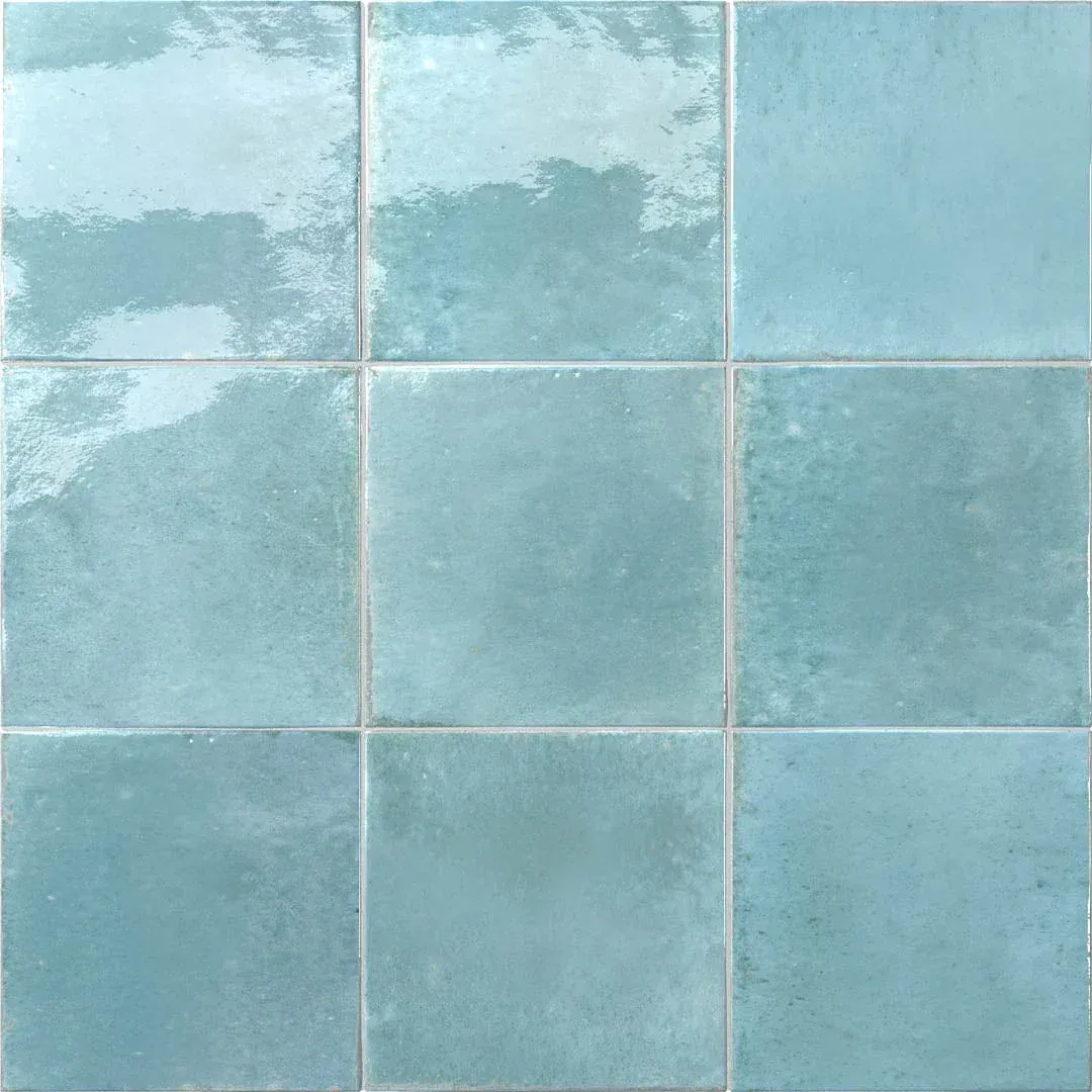 Pale blue ceramic tiles with white grout in a grid pattern