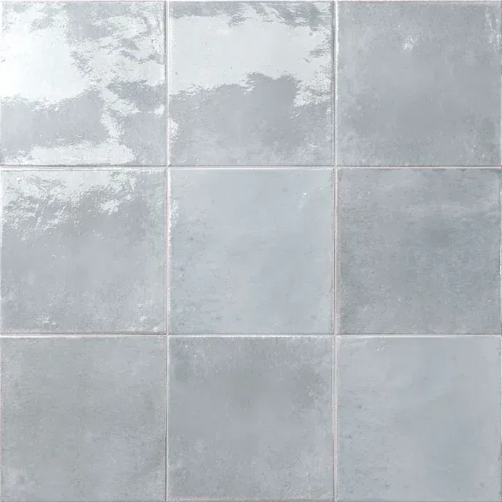 Light gray square wall tiles with a cloudy, mottled finish.
