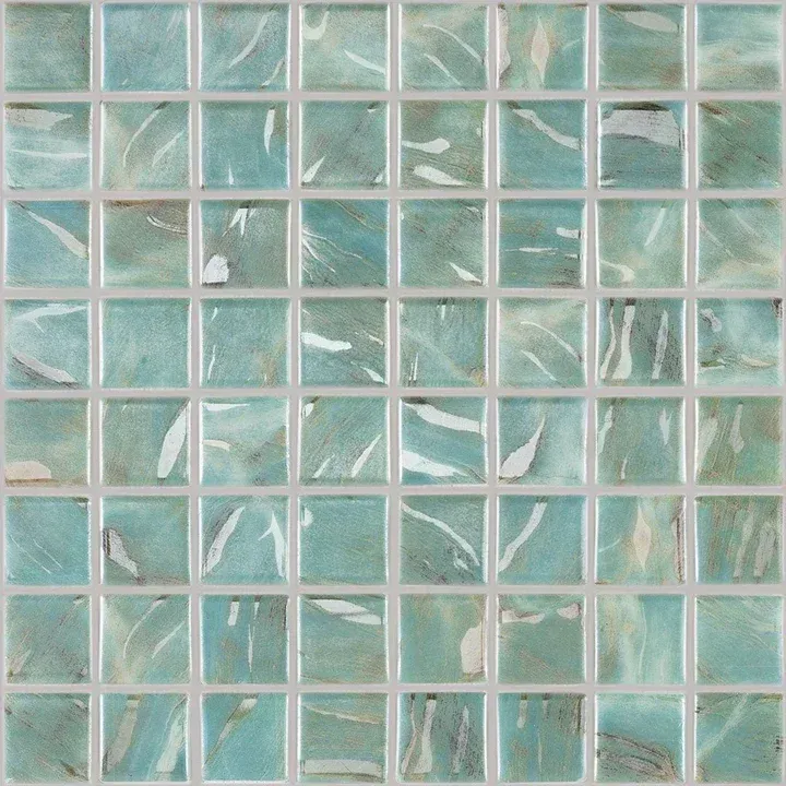 Close-up of glossy aqua and white mosaic tiles arranged in a grid.