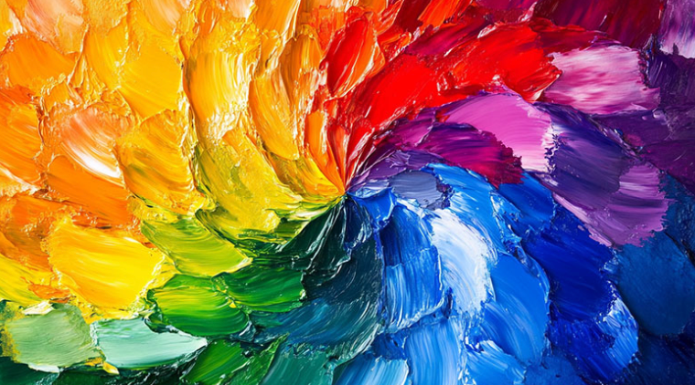 Vibrant abstract swirl of rainbow-colored paint strokes in yellow, green, blue, purple, and red