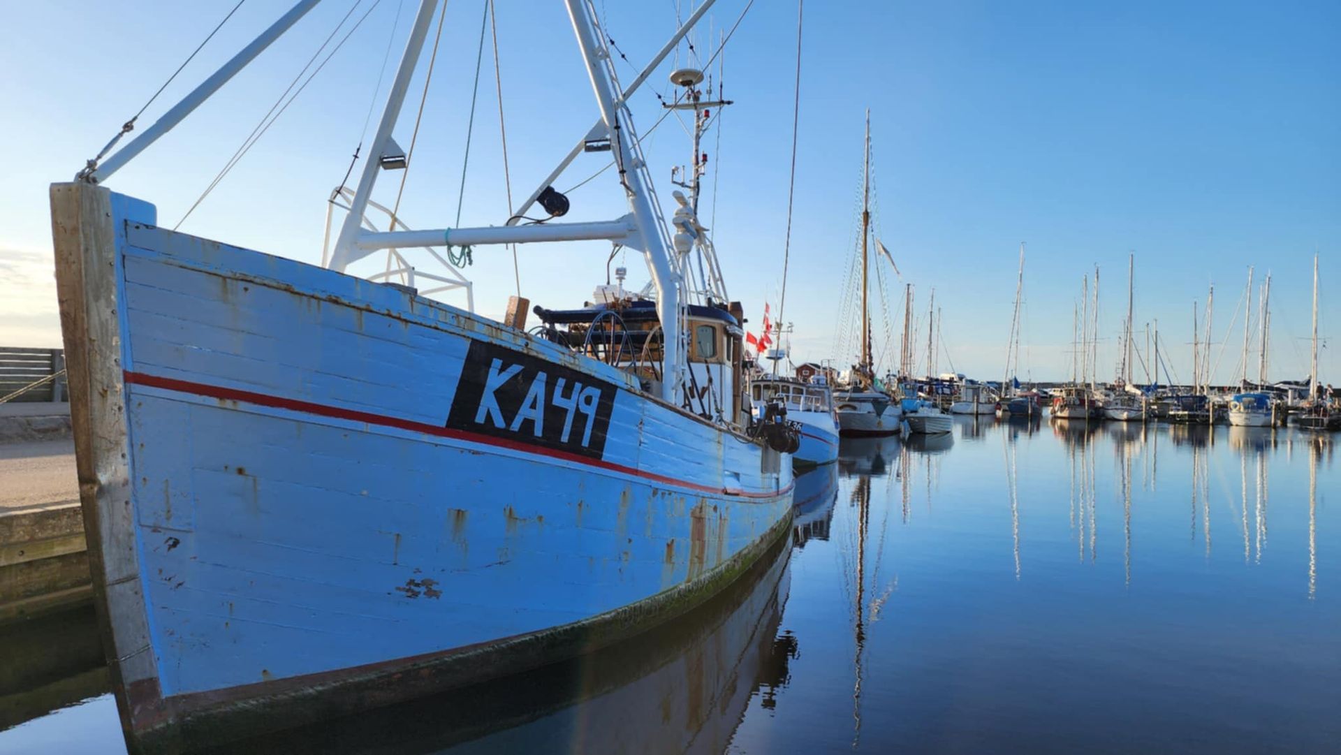 Blå kutter i en nærliggende hyggelig havn.