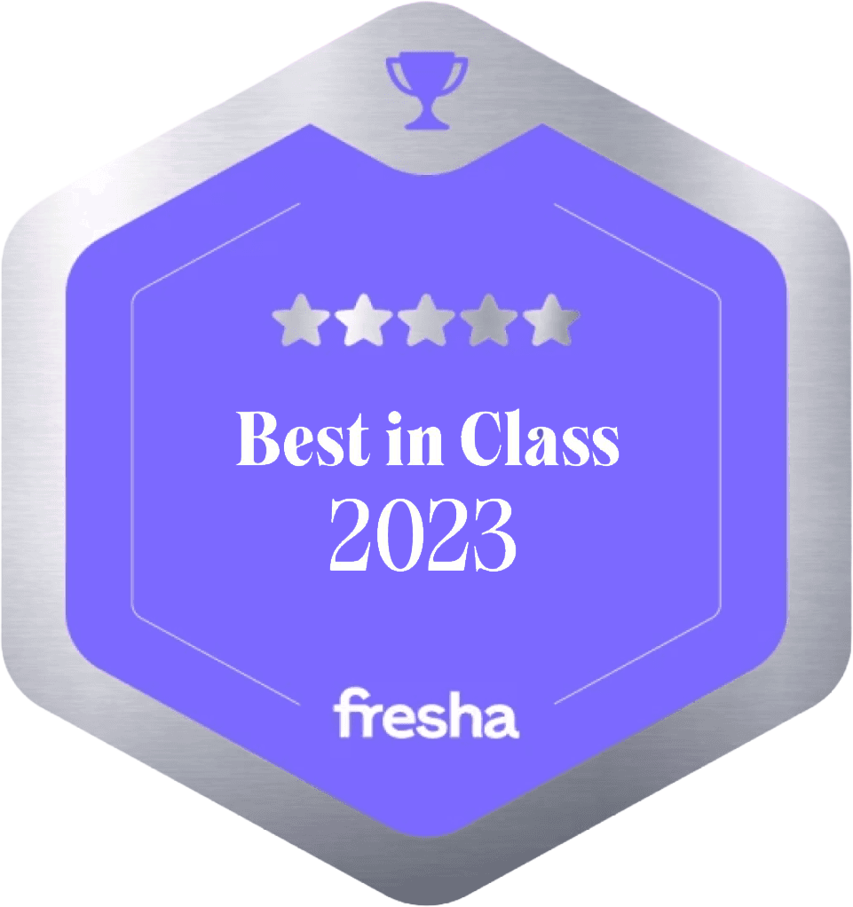 Purple hexagonal award badge with trophy icon, five stars, and “Best in Class 2023” plus “fresha” logo