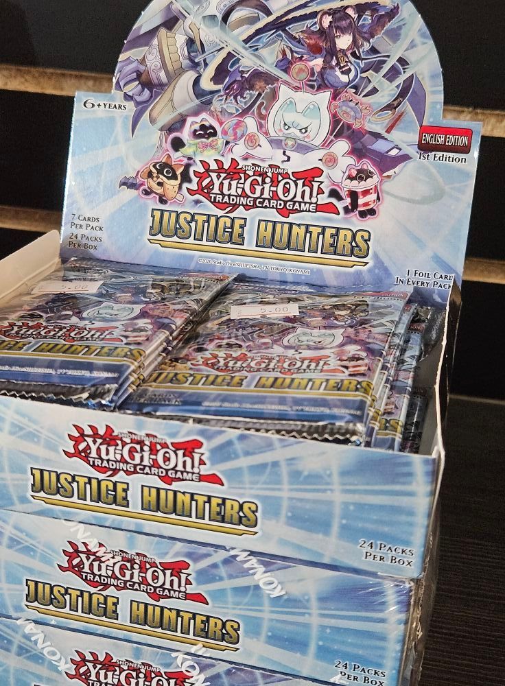 A box of Yu-Gi-Oh! Justice Hunters trading card booster packs. Blue and white packaging.