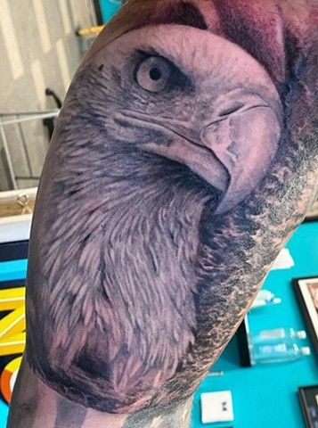 A close up of a tattoo of an eagle on a person 's arm.