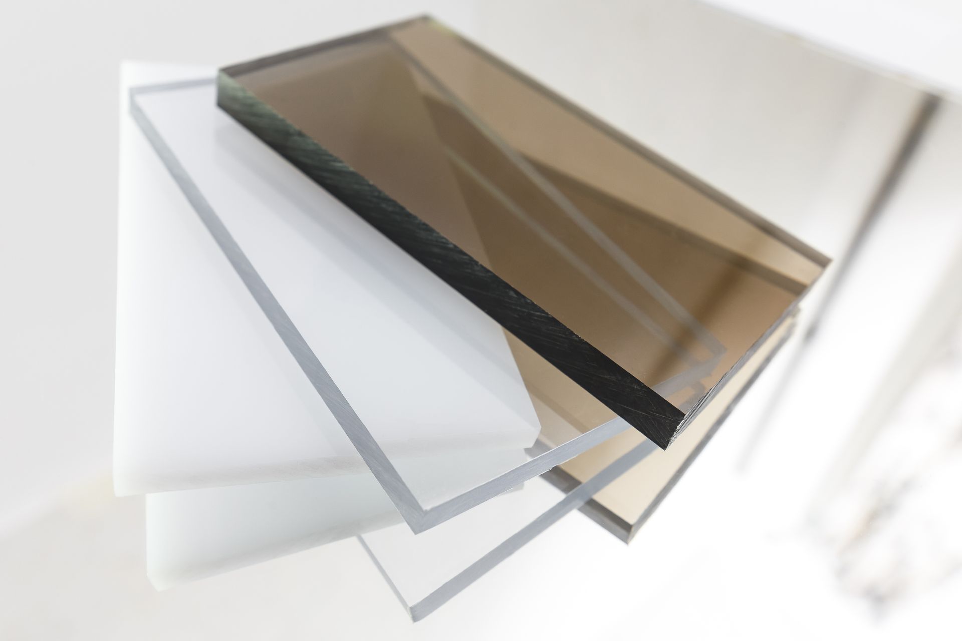 Solid polycarbonate and acrylic plastic sheets on display.