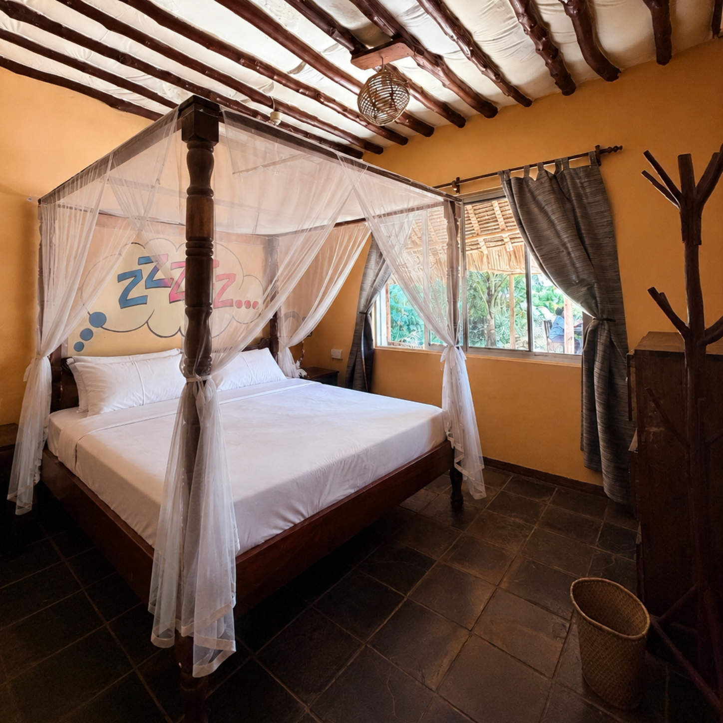 Bedroom with wooden doors to balcony overlooking a beach, white walls, bed with gray pillows, and ceiling fan.