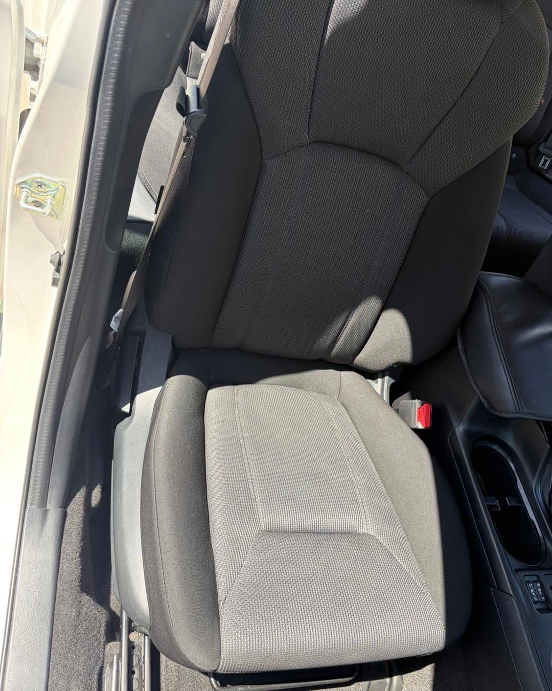 Gray car seat with a patterned cushion in a vehicle interior