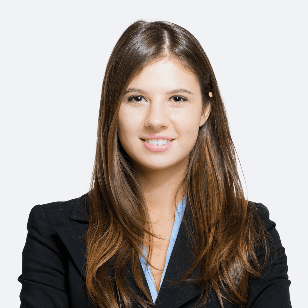 A woman with long brown hair is wearing a black jacket