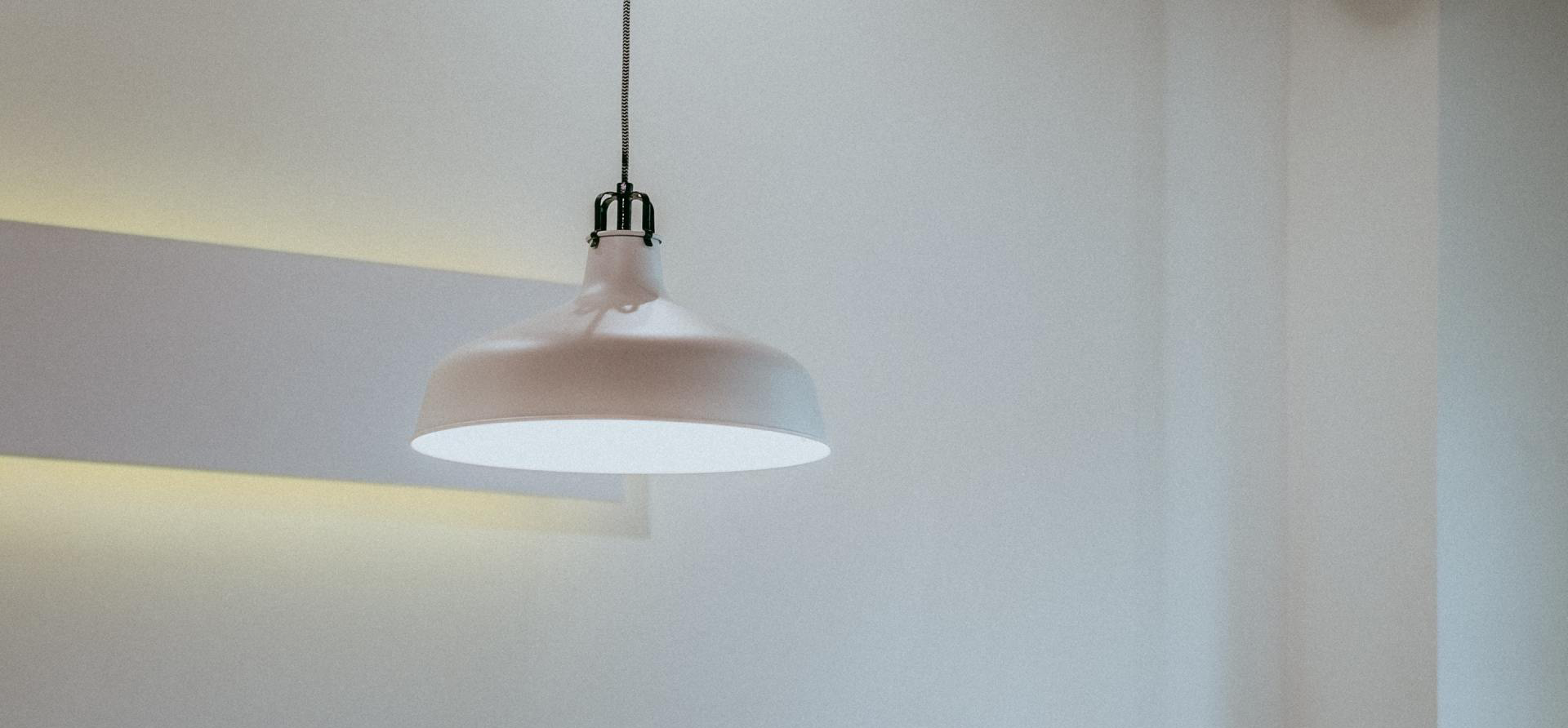 White pendant light hanging from ceiling.