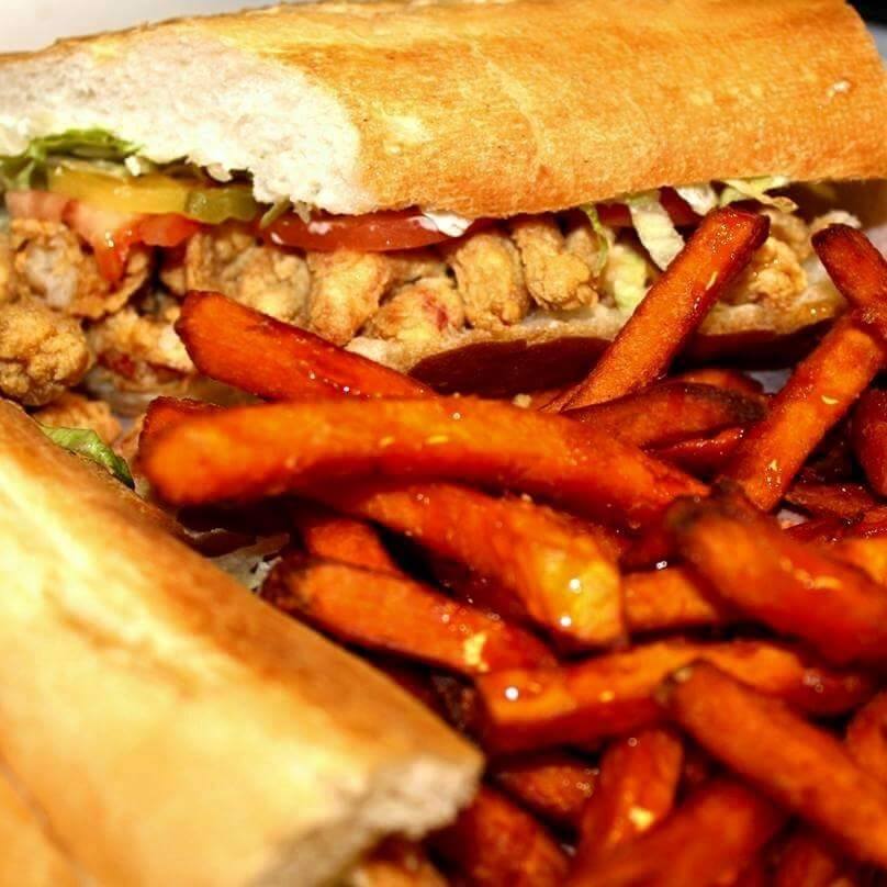 A close up of a sandwich and french fries