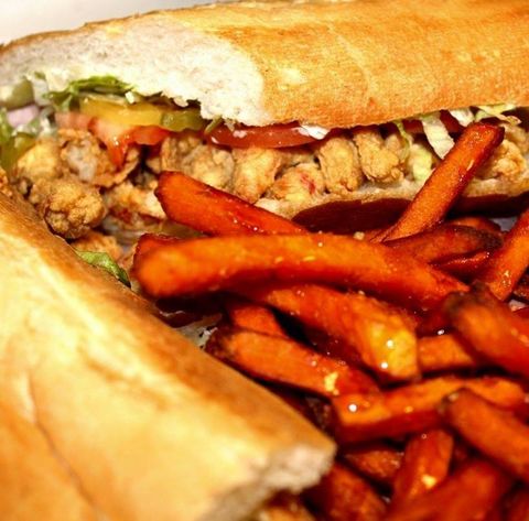 A close up of a sandwich and french fries