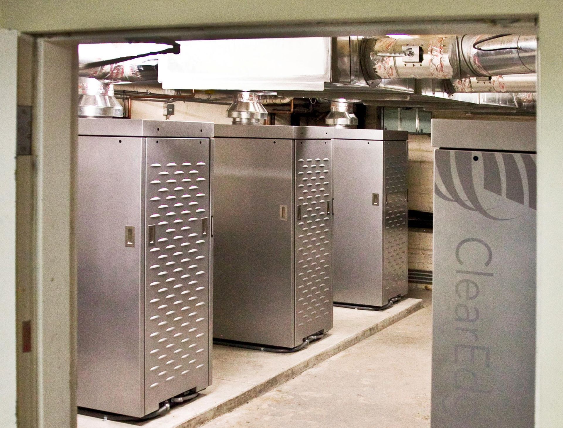 Four industrial metal units in a row, labeled