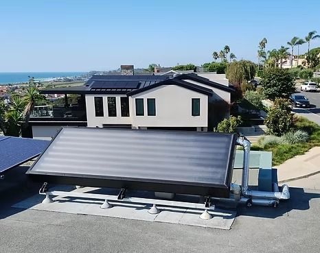 Person installing solar panel on a roof, connecting wires.