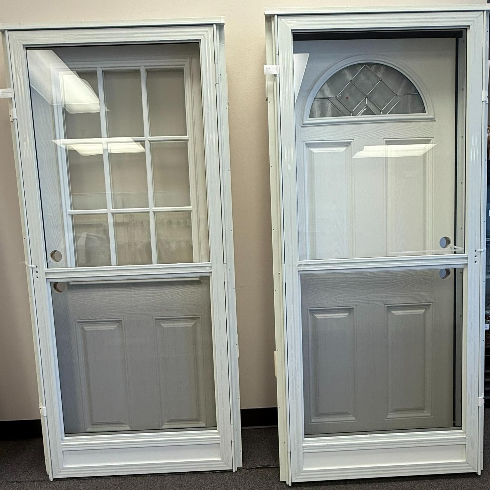 Two white screen doors with glass and lower panel, one with grid, one with arched top.