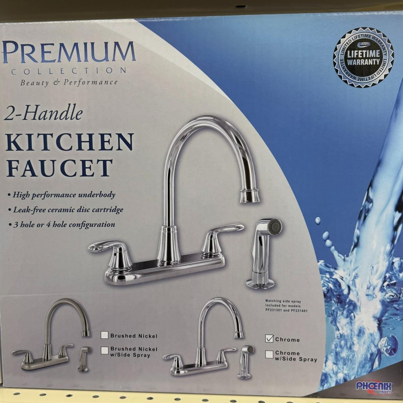 Boxed chrome kitchen faucet with two handles and a side sprayer, labeled 
