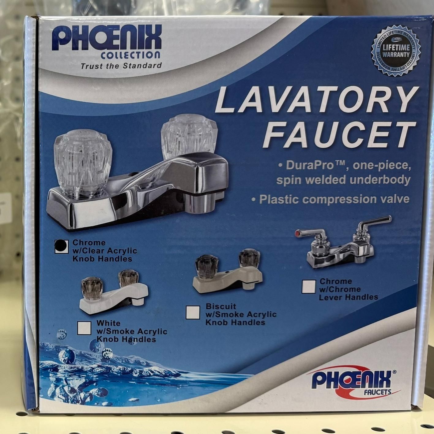 Boxed lavatory faucet with clear acrylic knob handles and product details.