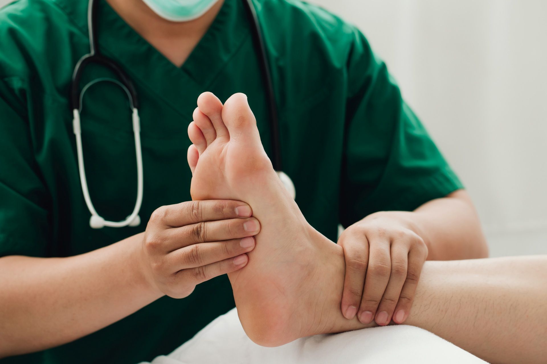 Doctor examining a patient’s foot in a clinic