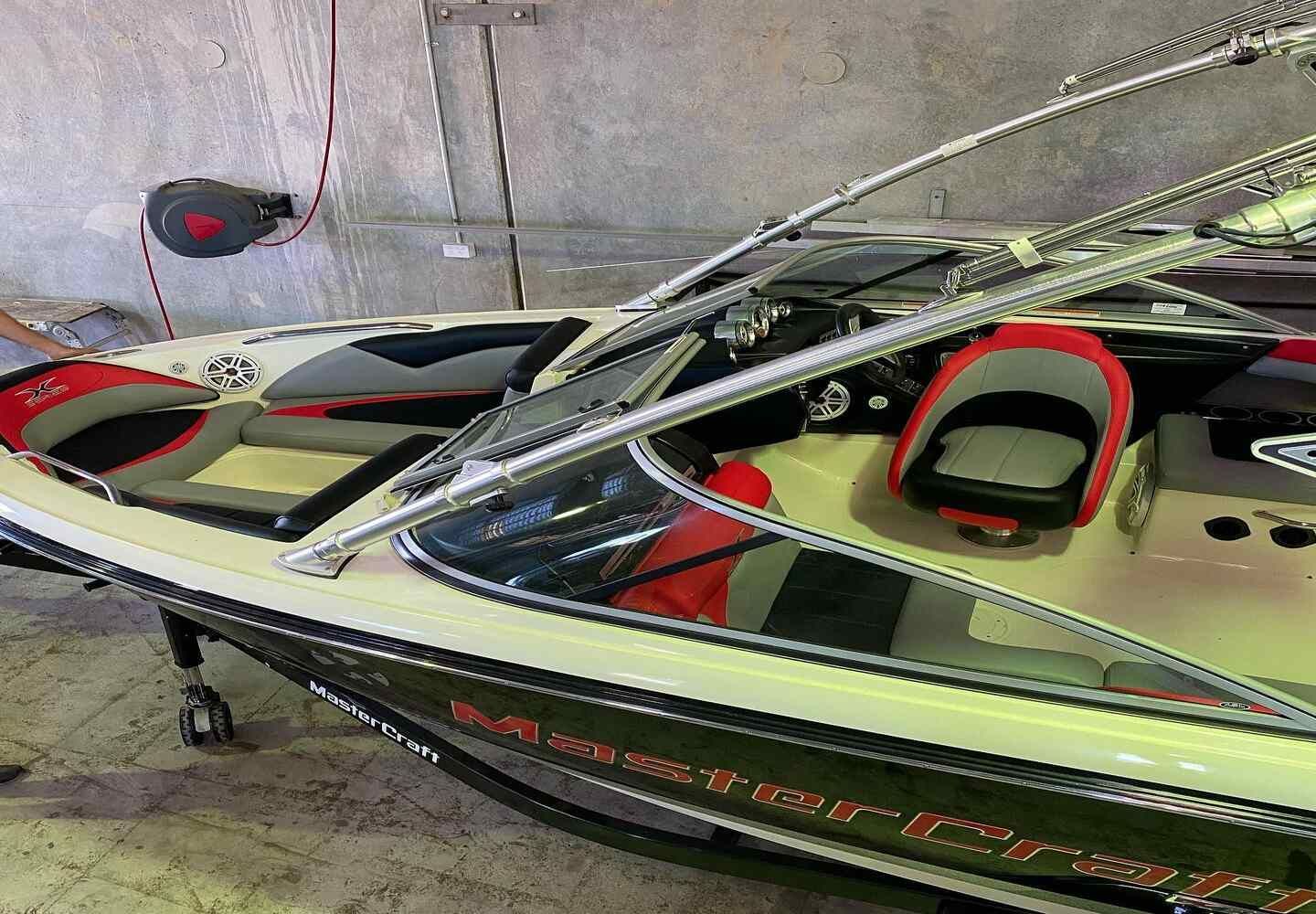 A White Boat With Red Seats Is Parked In A Garage — Currumbin Trimmers  In Currumbin Waters, QLD