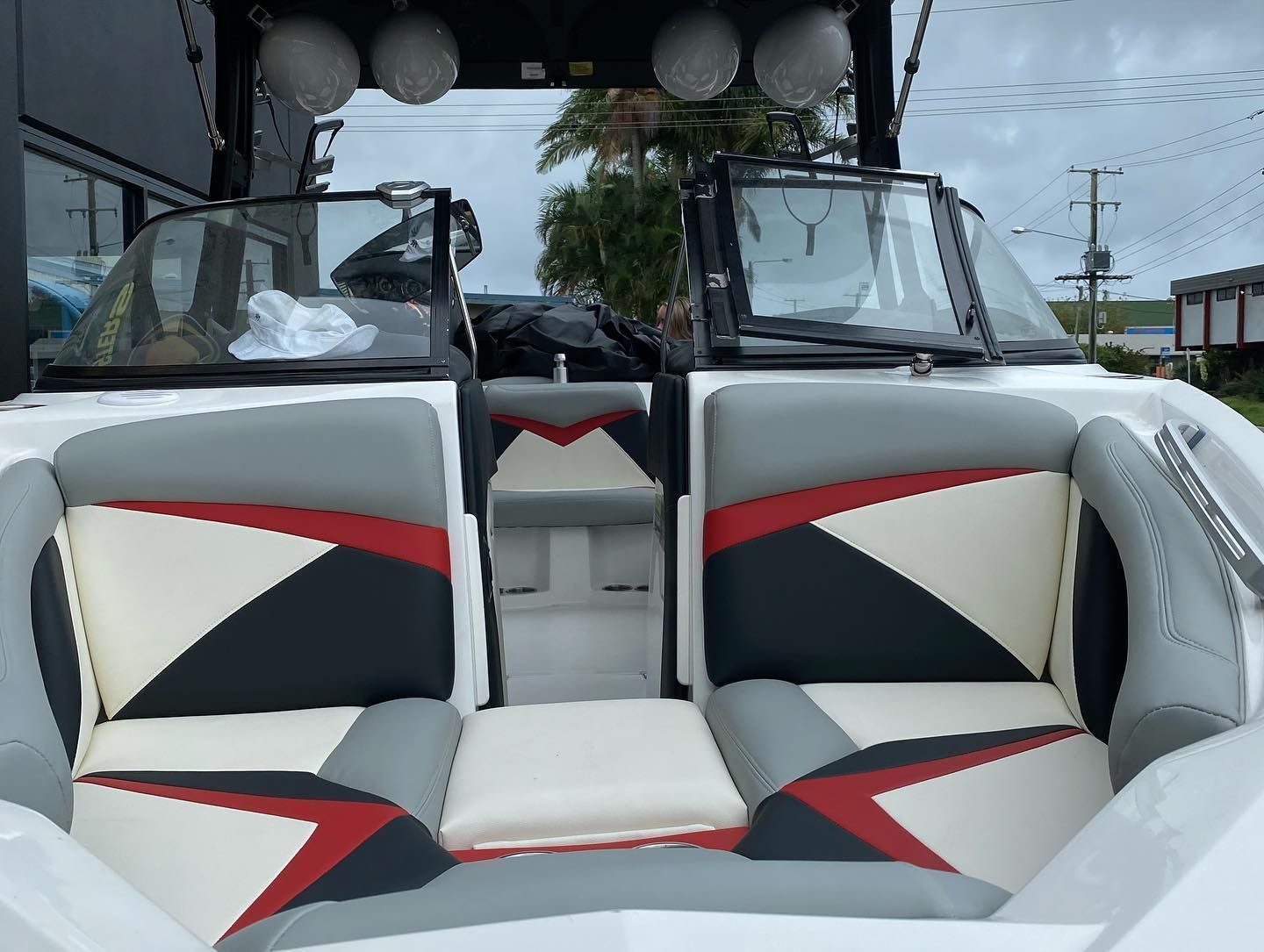 A White Boat With Red and Grey Seats — Currumbin Trimmers In Currumbin Waters, QLD