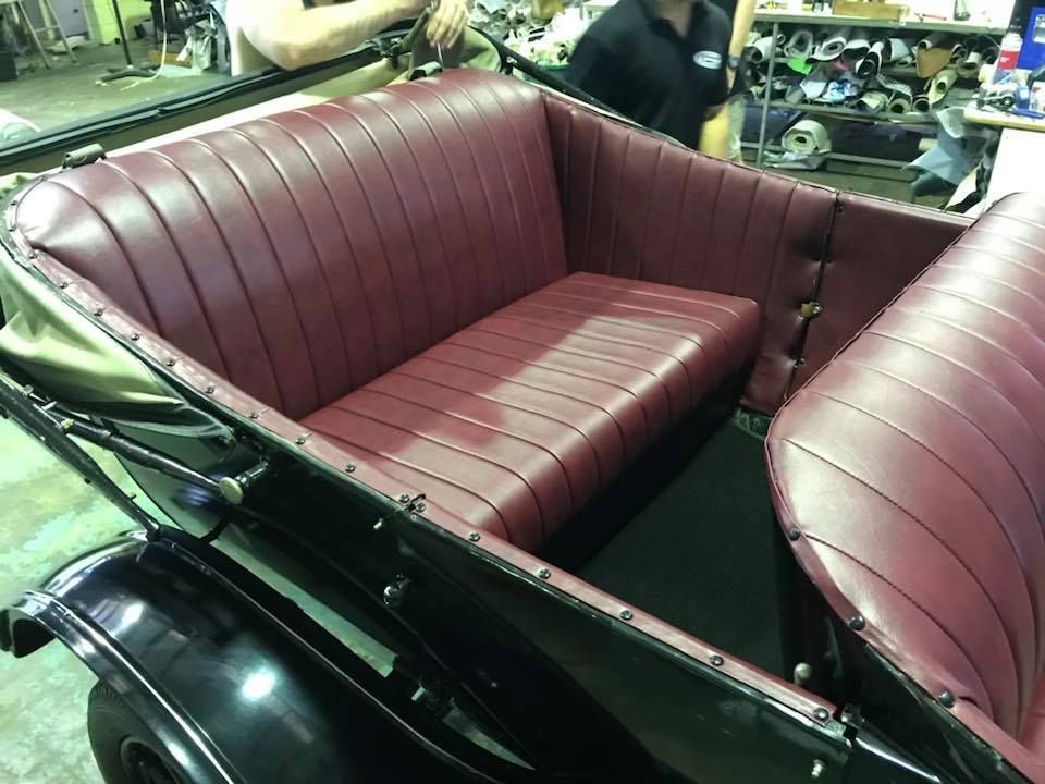 The Back Seat of an Old Car Has a Red Seat Cushion — Currumbin Trimmers In Kingscliff, NSW