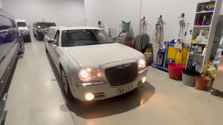 A White Limousine Is Parked In A Garage — Currumbin Trimmers In Currumbin Waters, QLD