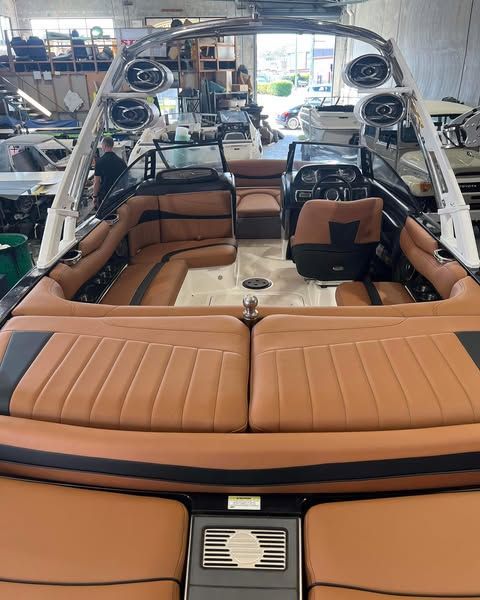 The Inside Of A Boat With Brown Leather Seats And Speakers — Currumbin Trimmers In Currumbin Waters, QLD