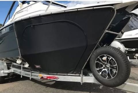 A Black And White Boat Is Parked On A Trailer — Currumbin Trimmers In Currumbin Waters, QLD