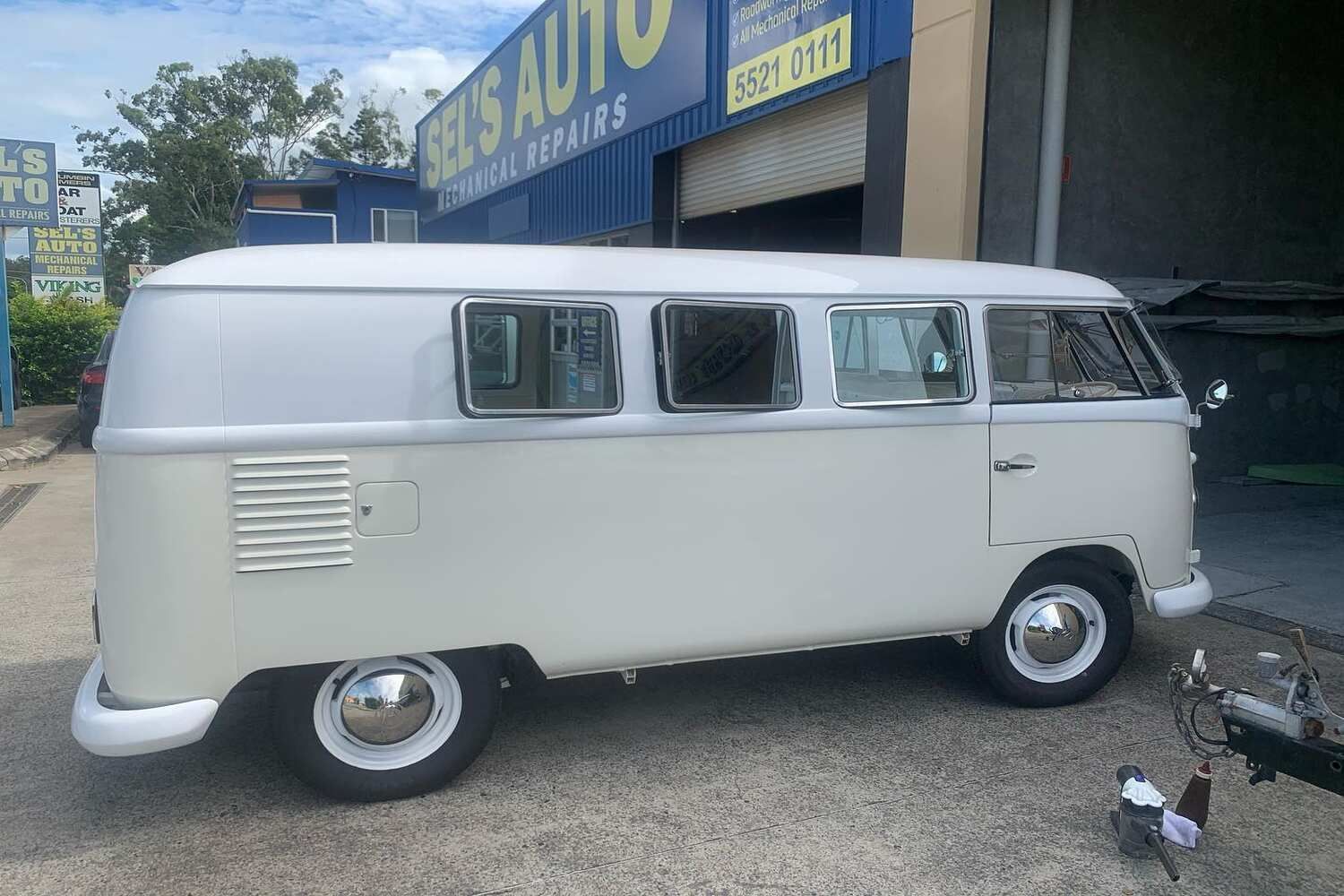 A White Van Is Parked In Front Of A Garage — Currumbin Trimmers  In Currumbin Waters, QLD