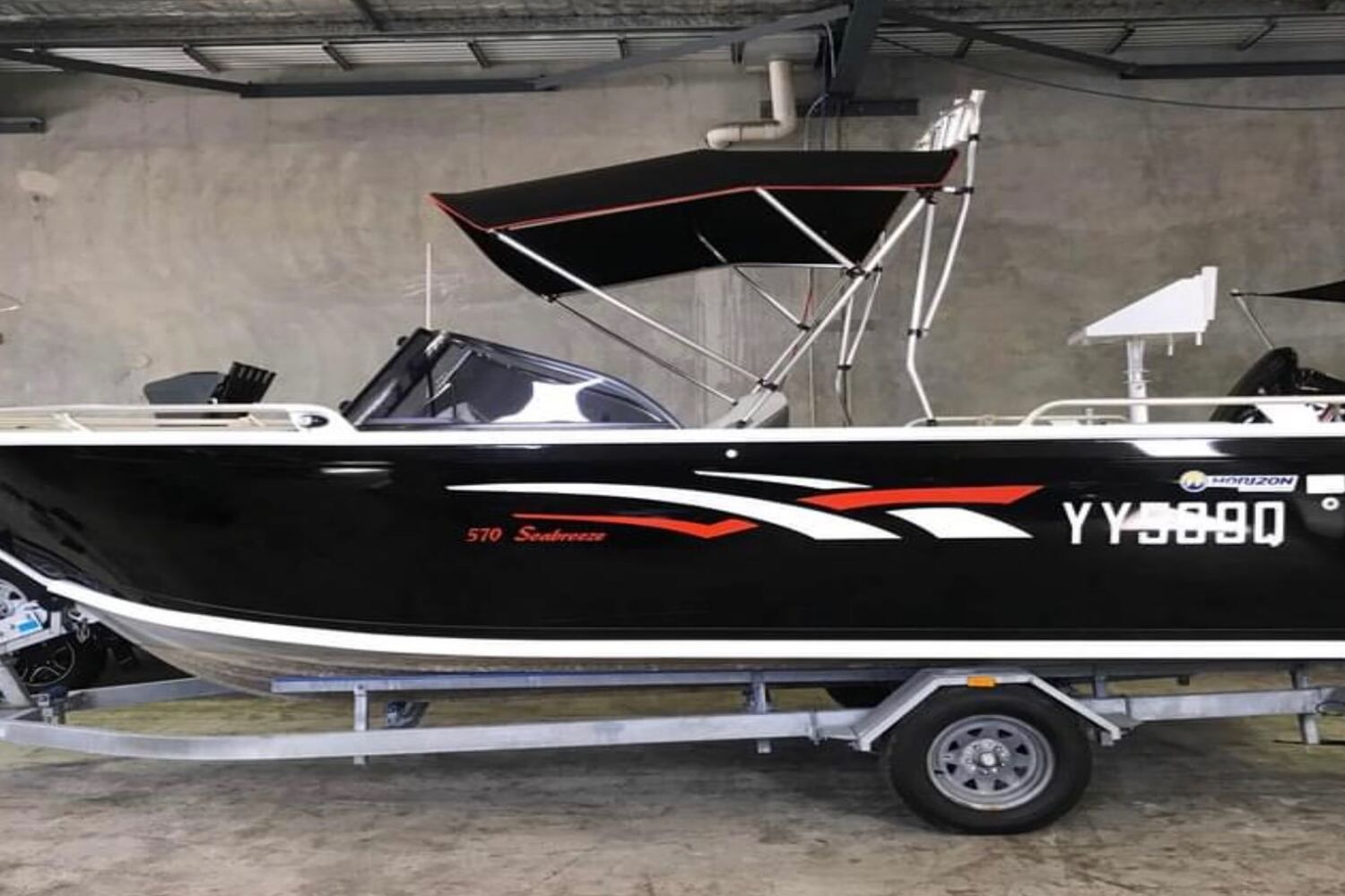 A Boat With A Canopy On Top Of It Is On A Trailer — Currumbin Trimmers  In Currumbin Waters, QLD