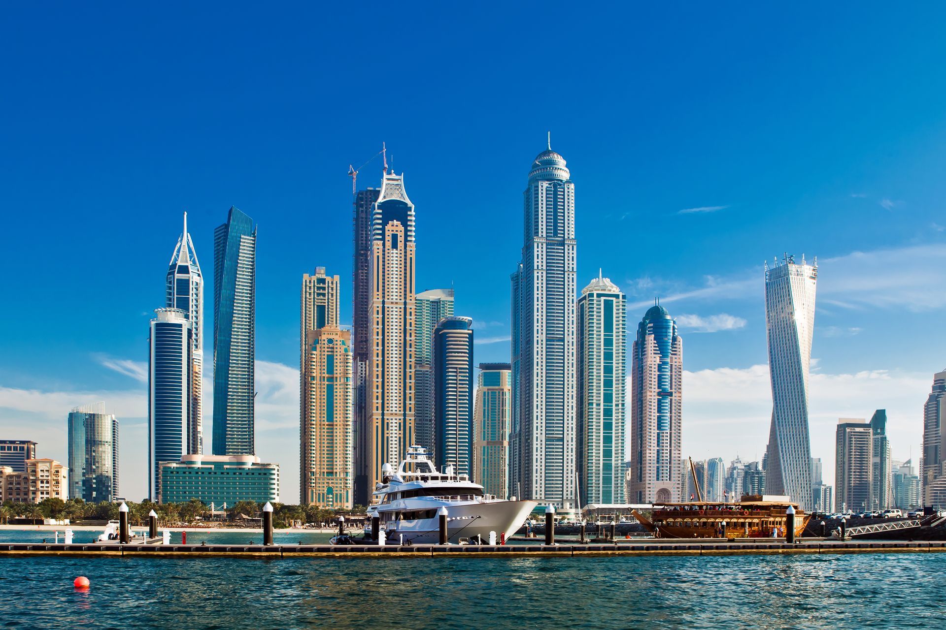 A city skyline with a boat docked in the foreground.