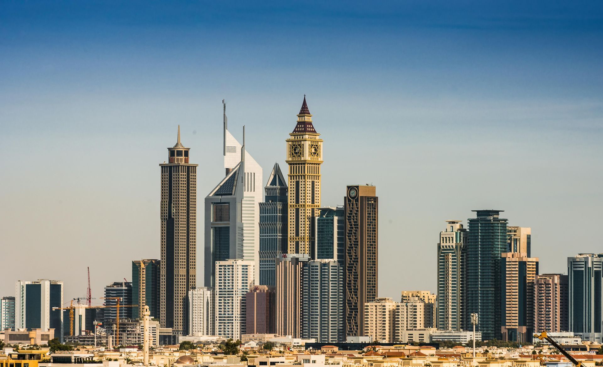 A city skyline with a clock tower in the middle of it.