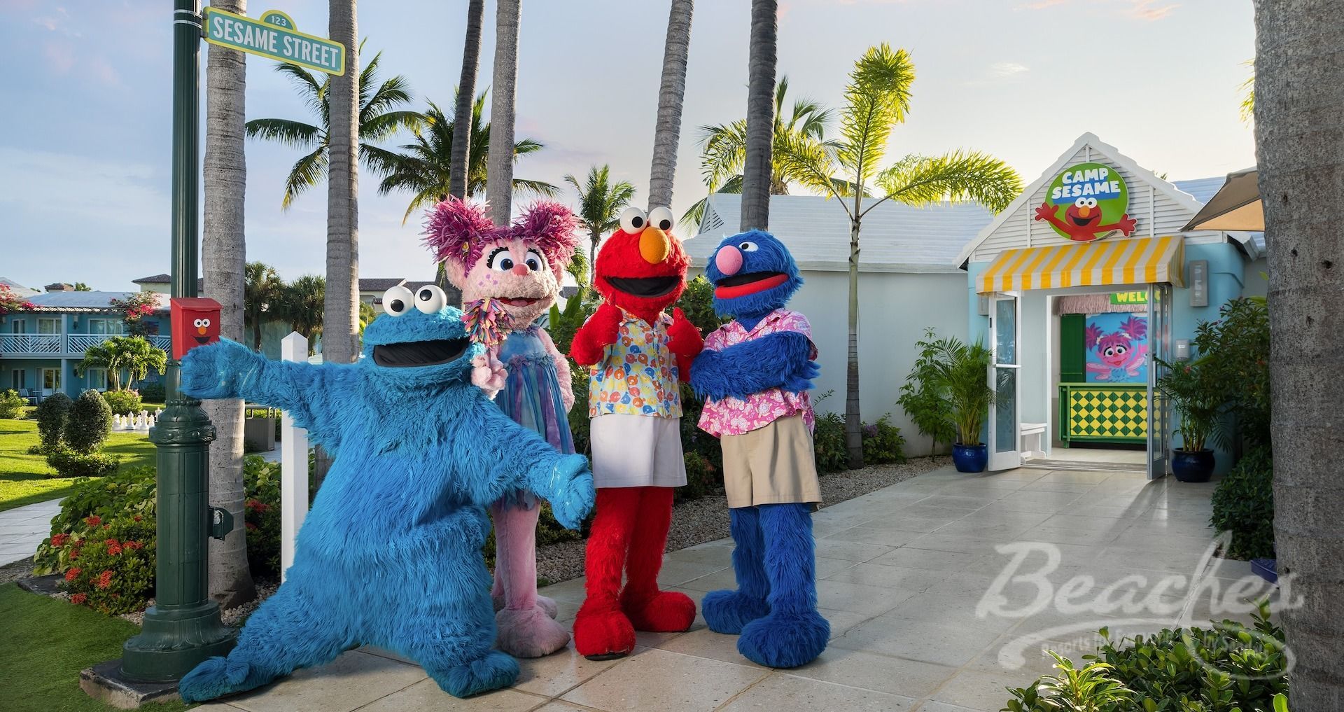 Sesame street characters are posing for a picture in front of a building