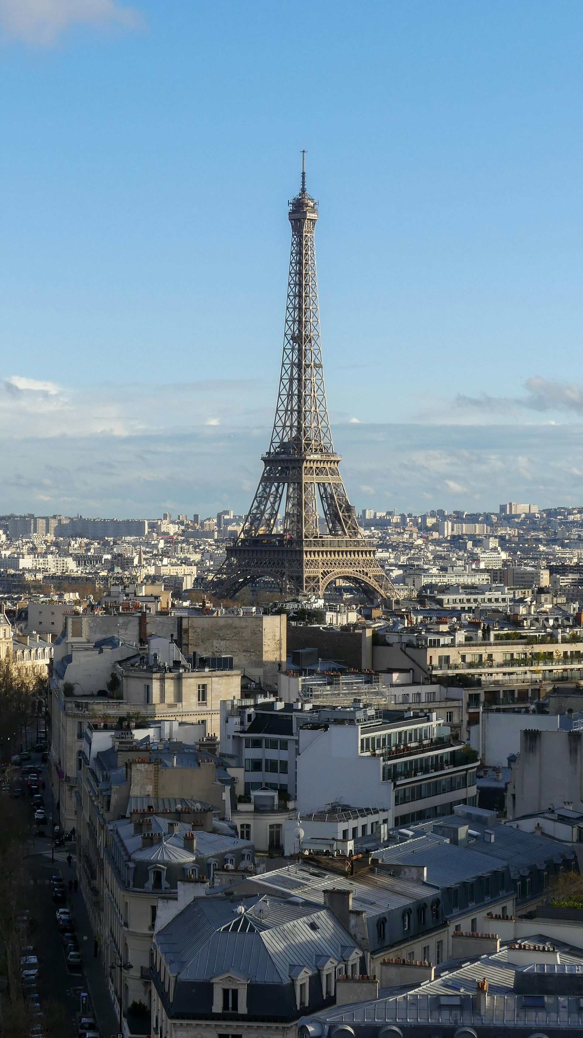 Eiffel Tower rising above Paris skyline under a clear blue sky
