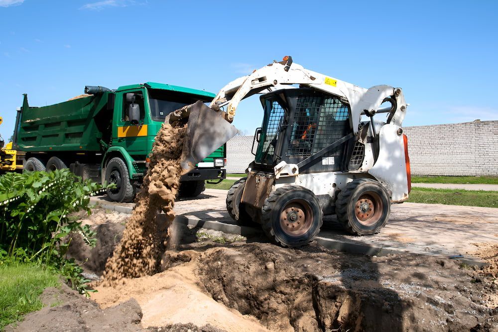 A Bulldozer Is Loading Dirt Into A Dump Truck — D.T. Fencing In Bakers Creek, QLD