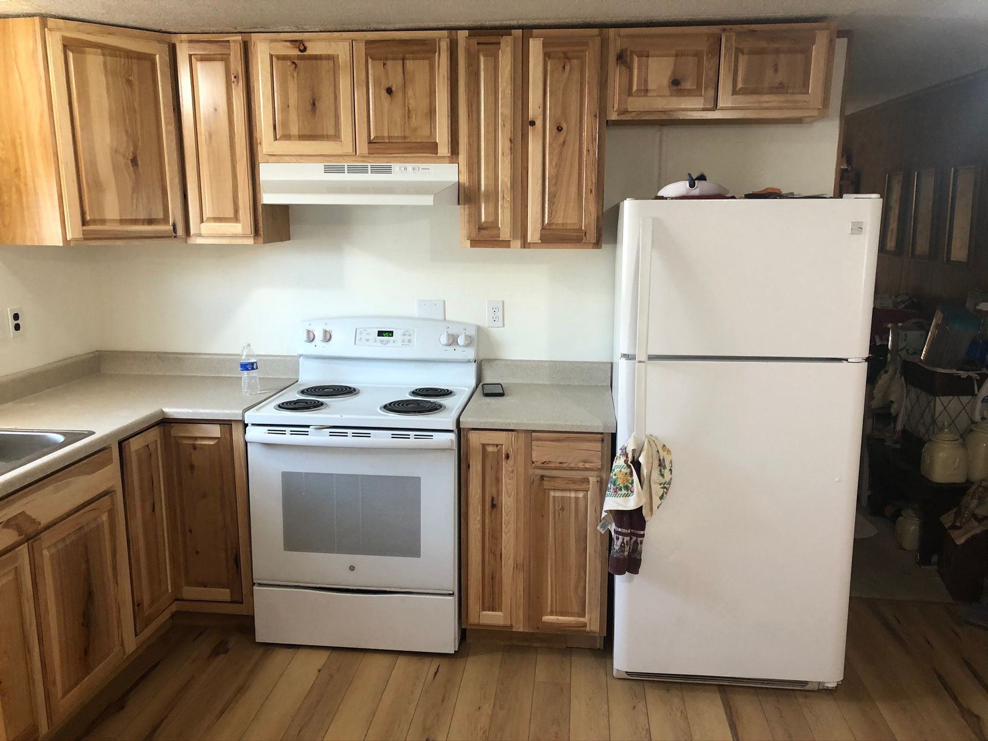 A kitchen with wooden cabinets and a white refrigerator